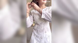 Beautiful young girl changing cloths front of camera