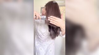 Beautiful young girl changing cloths front of camera